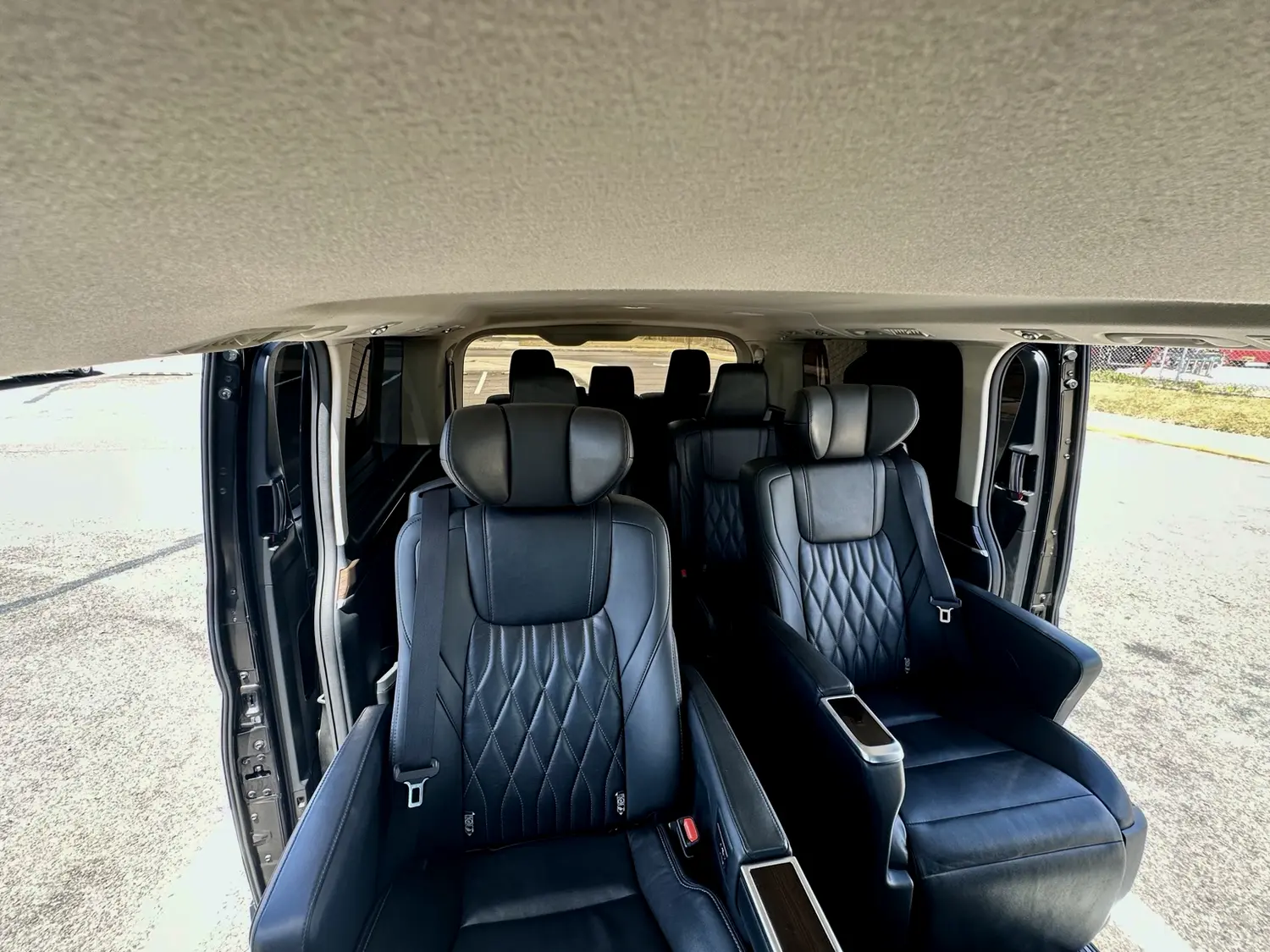Front captain-style seats and additional rows inside ASCEND's Toyota Hiace Majesty